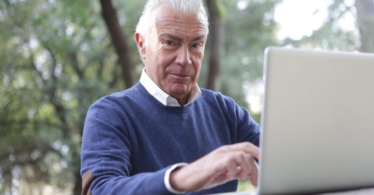 Reseting PSN Password to access old account on PS4? - Man in Blue Sweater Typing on Computer Laptop Reseting PSN Password to access old account on PS4? - Man in Blue Sweater Typing on Computer Laptop