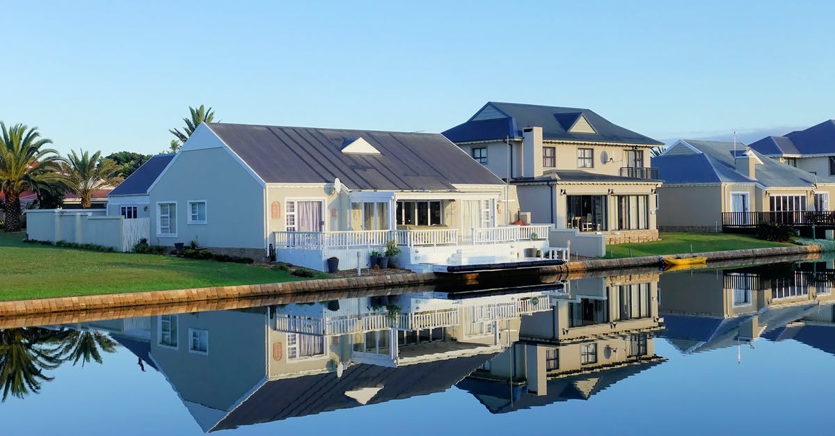 Residential buildings stuck at 0/0 - White Single-story Houses Beside Body of Water Residential buildings stuck at 0/0 - White Single-story Houses Beside Body of Water