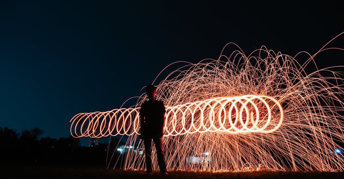 Respawn dynamics of command blocks in a Minecraft event - Male standing against glowing fire lights during night show