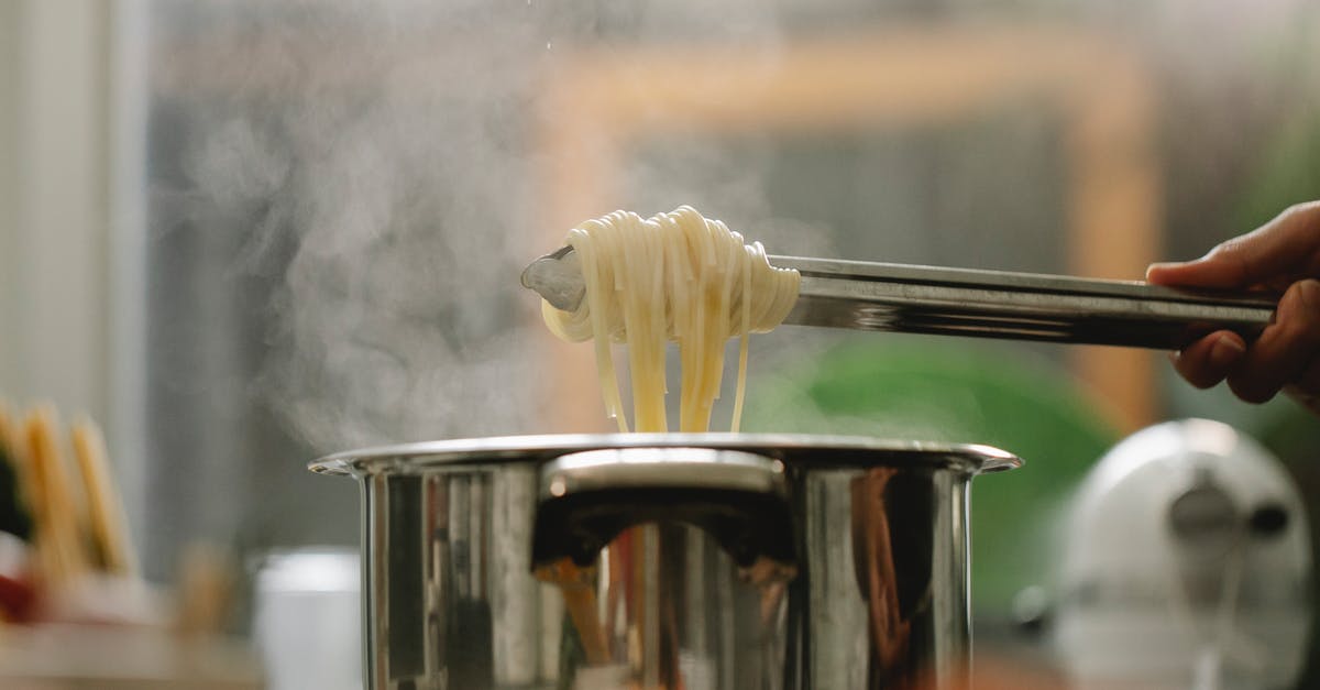 Restore Steam games from non-Steam backup [duplicate] - Low angle of crop anonymous chef taking spaghetti from pan with boiling steaming water