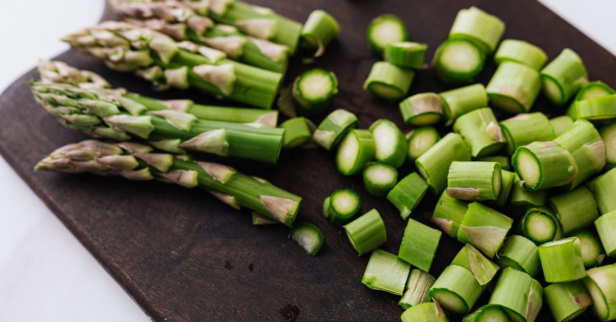 Restore Steam games from non-Steam backup [duplicate] - Closeup of green chopped stems of asparagus placed on wooden cutting board on white surface