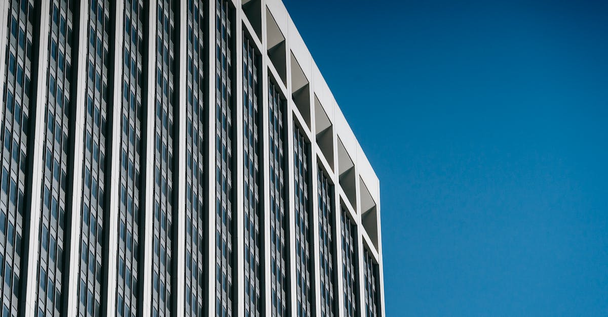 Restoring my Tiny Tower progress from Game Center? - Low angle facade of contemporary multistory skyscraper with many windows against blue sky Restoring my Tiny Tower progress from Game Center? - Low angle facade of contemporary multistory skyscraper with many windows against blue sky