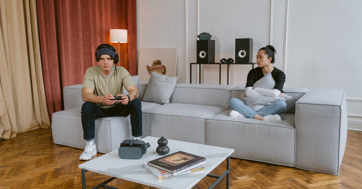retrieving a Coc account/game - Man and Woman Sitting on Couch retrieving a Coc account/game - Man and Woman Sitting on Couch