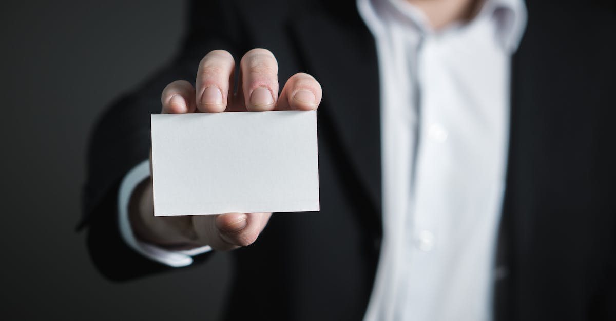 Returning a Card to hand & Charge - Close-up of Hand Holding Text over Black Background Returning a Card to hand & Charge - Close-up of Hand Holding Text over Black Background