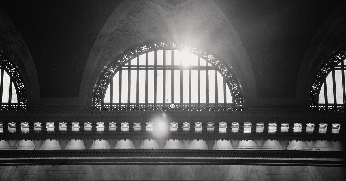 Rewards of Hall of Monuments [duplicate] - Ornamental arched window in historic building in sun rays