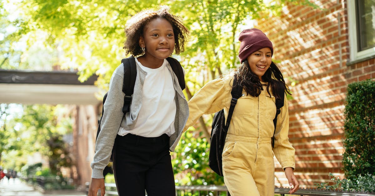 Right time to build school - Cheerful friends walking together in sunny day Right time to build school - Cheerful friends walking together in sunny day