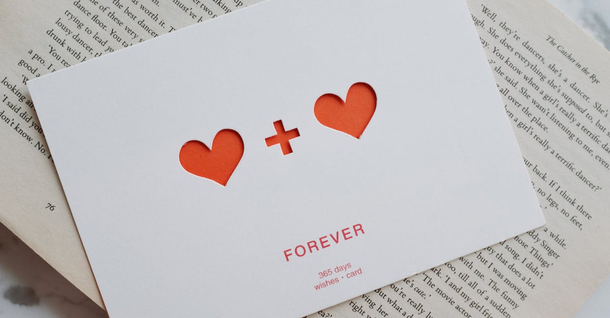 Roblox games take forever to open - Top view of white paper postcard with cutout red hearts placed on top of opened novel book Roblox games take forever to open - Top view of white paper postcard with cutout red hearts placed on top of opened novel book