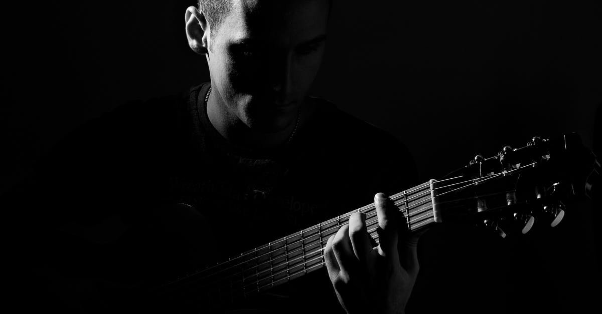 Rock band instrument compatibility - Grayscale Photo of Man Playing Guitar Rock band instrument compatibility - Grayscale Photo of Man Playing Guitar