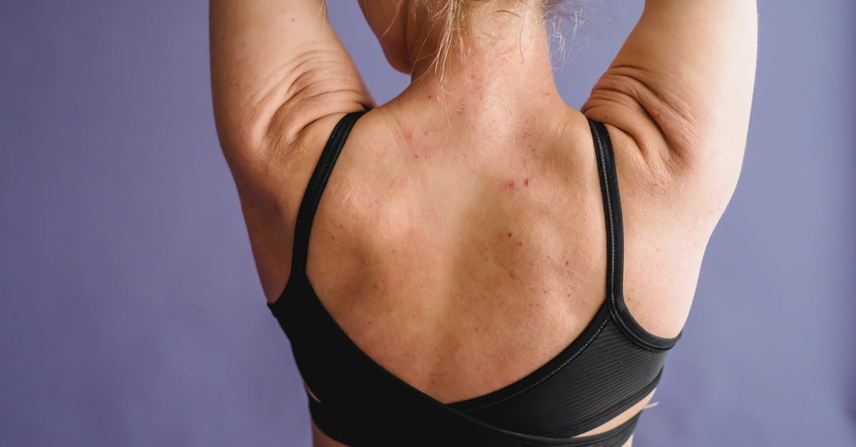 Ronnie Shaw stole my power armor, how to get it back - Back view of crop anonymous female with muscular arms on purple background of studio Ronnie Shaw stole my power armor, how to get it back - Back view of crop anonymous female with muscular arms on purple background of studio