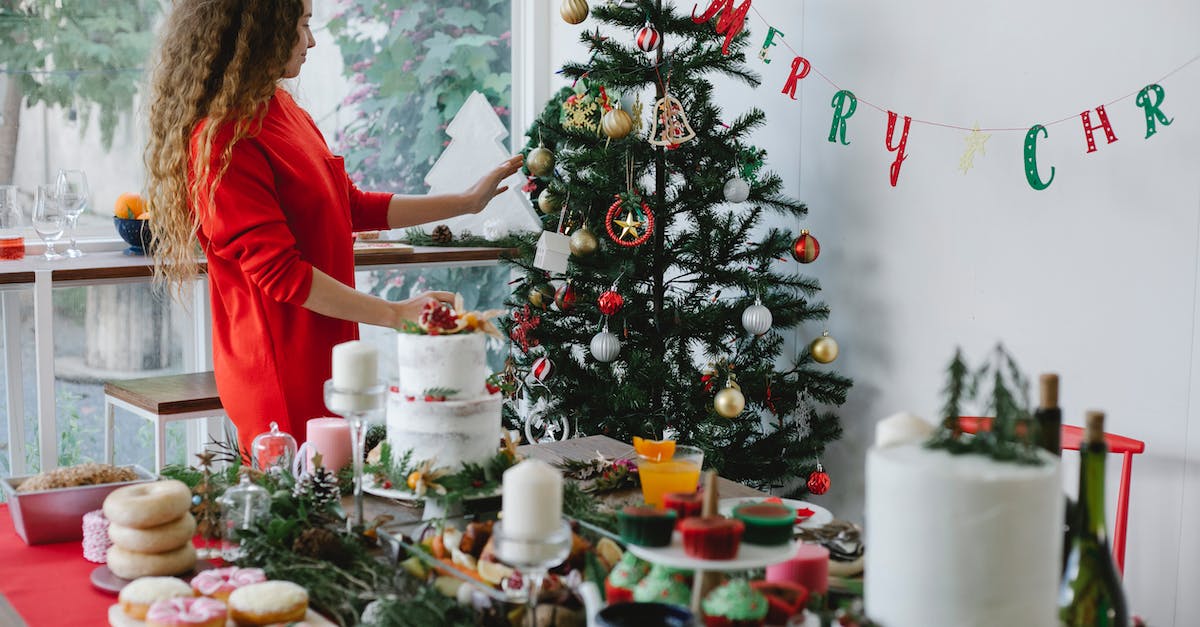 Room Designations and the "Home Sweet Home" Achievement - Woman decorating Christmas tree in house room with assorted desserts