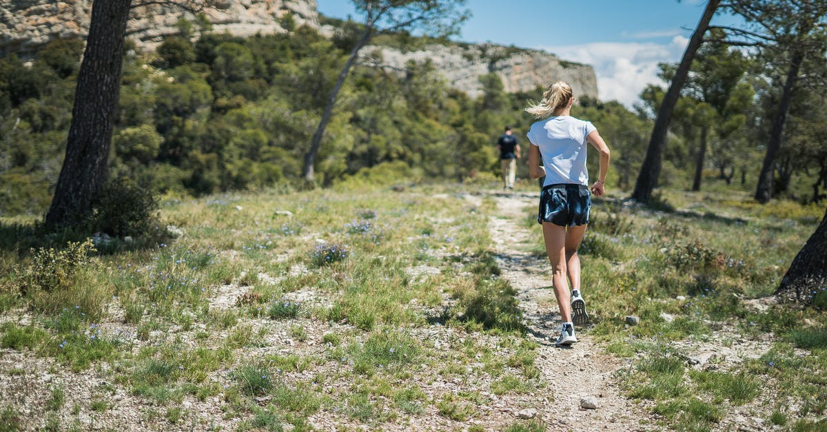 Running around for Exploration experience - Woman in White T-shirt Running on the Field