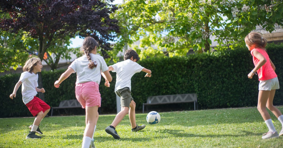 Running games in DirectX 6 - Young Kids Playing Football on the Field