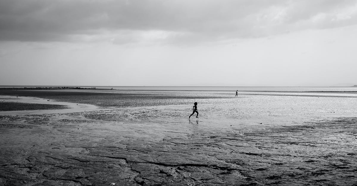 Running Low on Limestone - Silhouette of Running Child on Beach Running Low on Limestone - Silhouette of Running Child on Beach