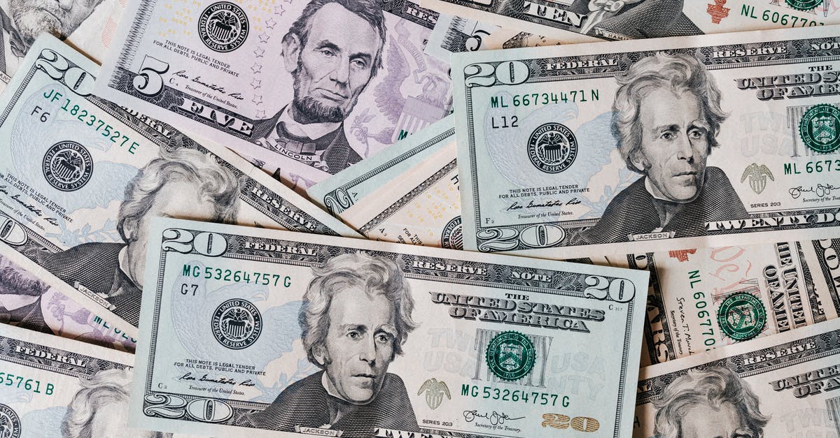 Saving on DOSBox - Top view of different types and colors American dollars placed together on each other Saving on DOSBox - Top view of different types and colors American dollars placed together on each other