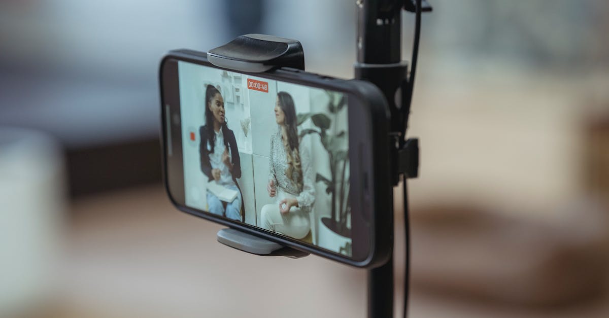 SC2 camera positioning easy way? - Modern smartphone on tripod recording video of content stylish women having friendly conversation SC2 camera positioning easy way? - Modern smartphone on tripod recording video of content stylish women having friendly conversation
