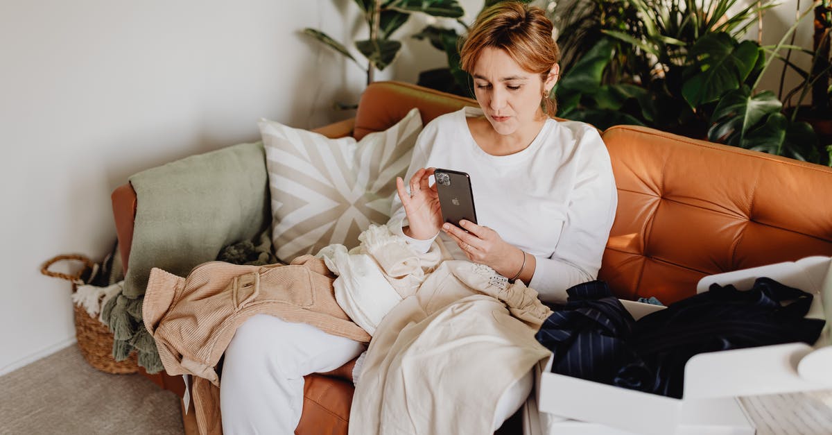 Scrolling malfunction - Woman Sitting on a Couch and Using Phone Scrolling malfunction - Woman Sitting on a Couch and Using Phone