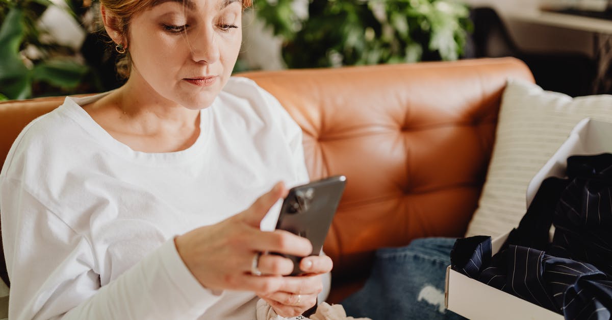 Scrolling malfunction - Woman Sitting on a Couch Using Her Phone Scrolling malfunction - Woman Sitting on a Couch Using Her Phone
