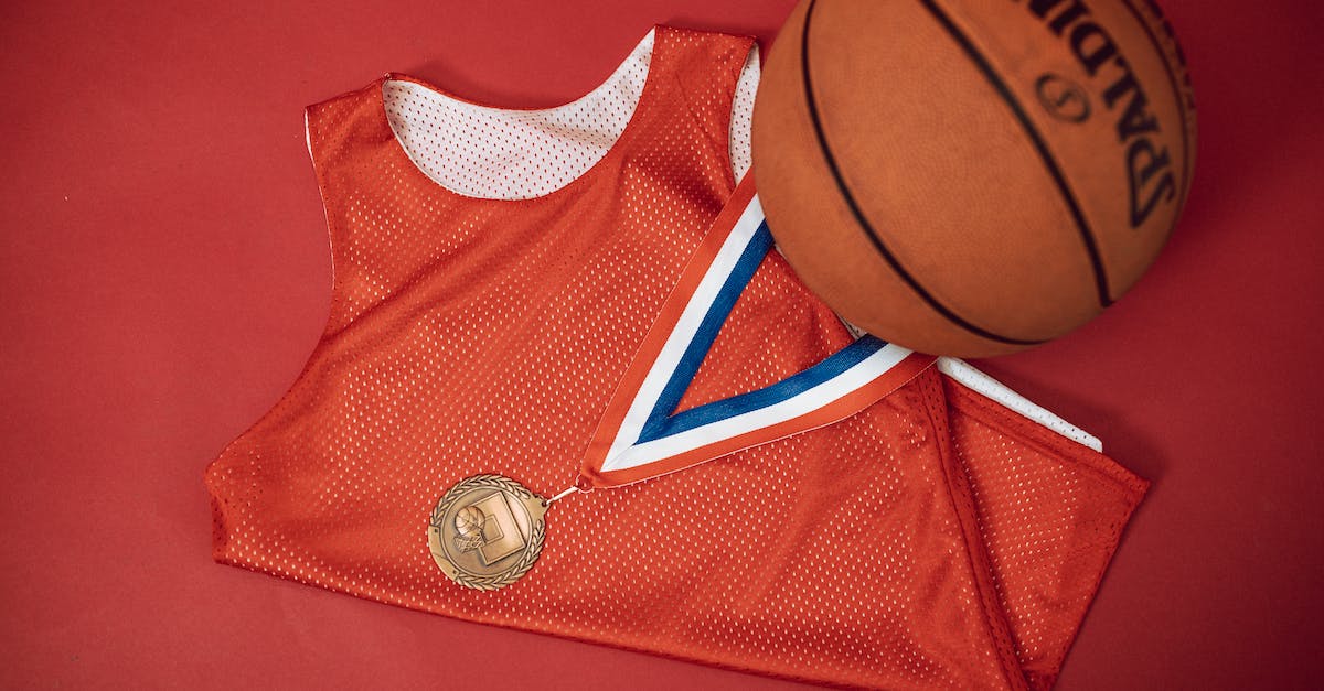 Seer Medal after 2014 - A Bronze Medal on Red Jersey Shirt Beside a Basketball on Red Surface Seer Medal after 2014 - A Bronze Medal on Red Jersey Shirt Beside a Basketball on Red Surface