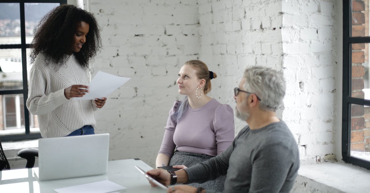 Separate world files for each person's profile using the minecraft launcher on that computer - Concentrated diverse colleagues of different ages using gadgets and working on project together