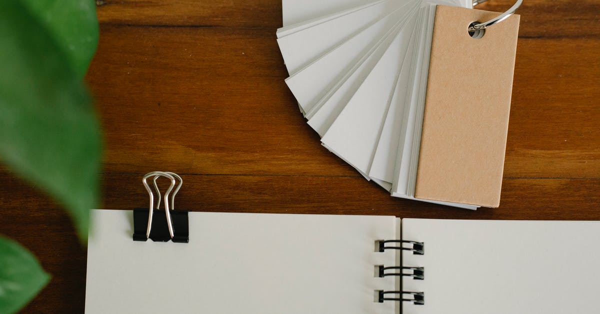 Set a tag on slots/hotbars - Top view of set of blank labels placed on wooden table near planner with paper clip Set a tag on slots/hotbars - Top view of set of blank labels placed on wooden table near planner with paper clip