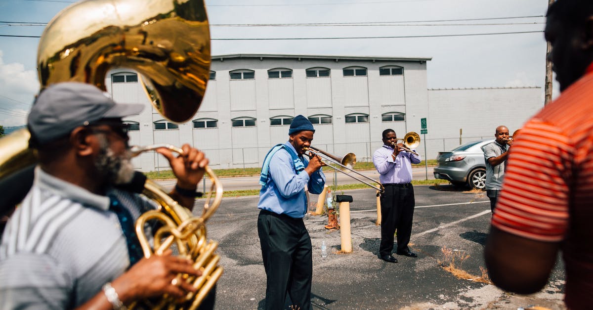 Setting up local Minecraft for multiple player - Happy black men playing music together on sunny day Setting up local Minecraft for multiple player - Happy black men playing music together on sunny day