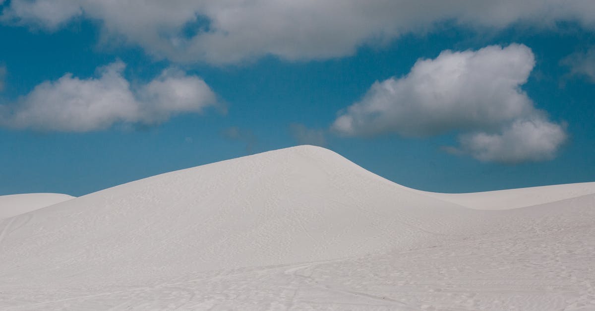 SetWorldSpawn Below Surface in MCJE 1.16 - From below of pure blue sky with clouds over empty endless desert landscape with wheels and shoes tracks on surface