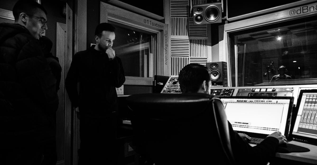 Several Screen Recording Softwares Tested, All Create Empty Black Frames - Black and white of unrecognizable sound man working on desktop computer using musical software while sitting in chair near pensive colleagues in recording studio Several Screen Recording Softwares Tested, All Create Empty Black Frames - Black and white of unrecognizable sound man working on desktop computer using musical software while sitting in chair near pensive colleagues in recording studio