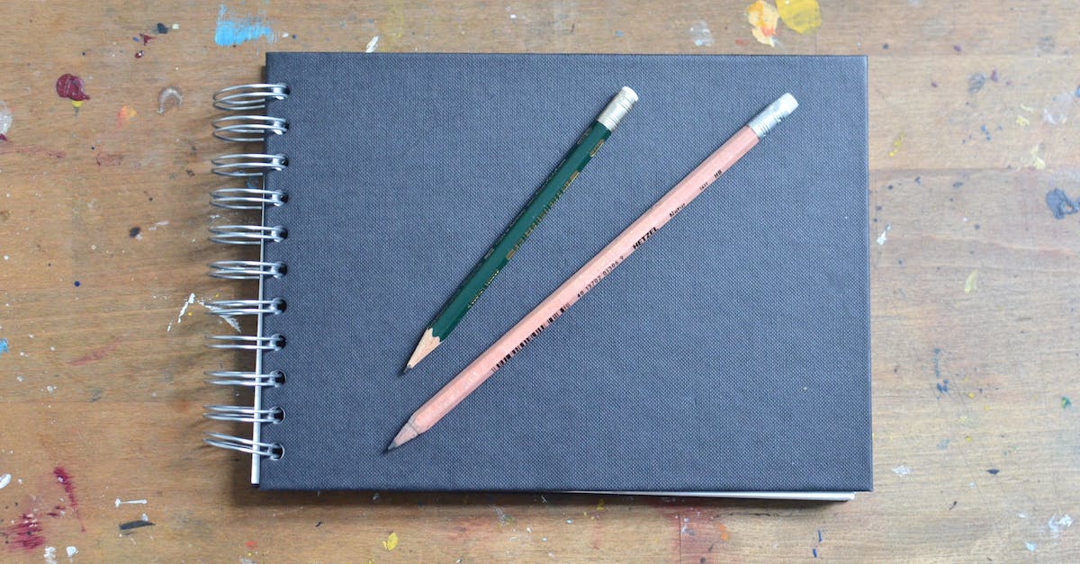 Several Screen Recording Softwares Tested, All Create Empty Black Frames - Top view of blank black notepad with pencils placed on shabby wooden surface stained with colourful paints Several Screen Recording Softwares Tested, All Create Empty Black Frames - Top view of blank black notepad with pencils placed on shabby wooden surface stained with colourful paints