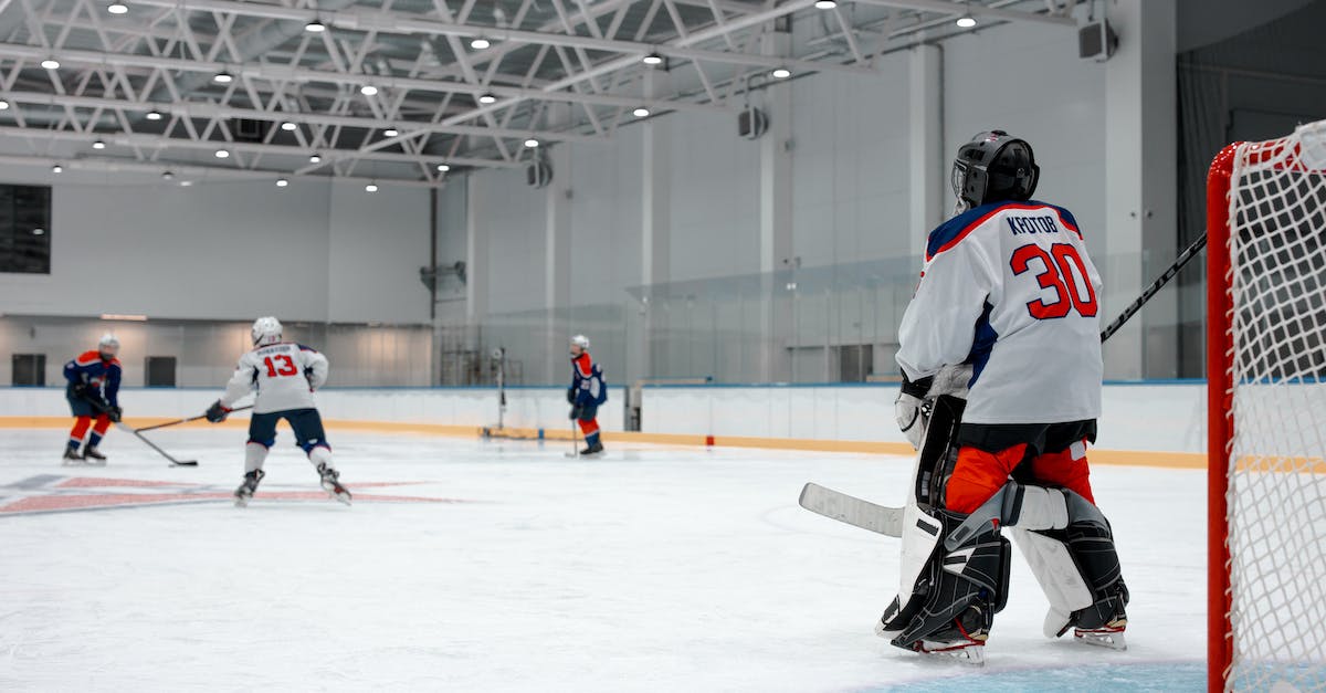 Shaking Off Players - Man in White Ice Hockey Jersey Playing Hockey