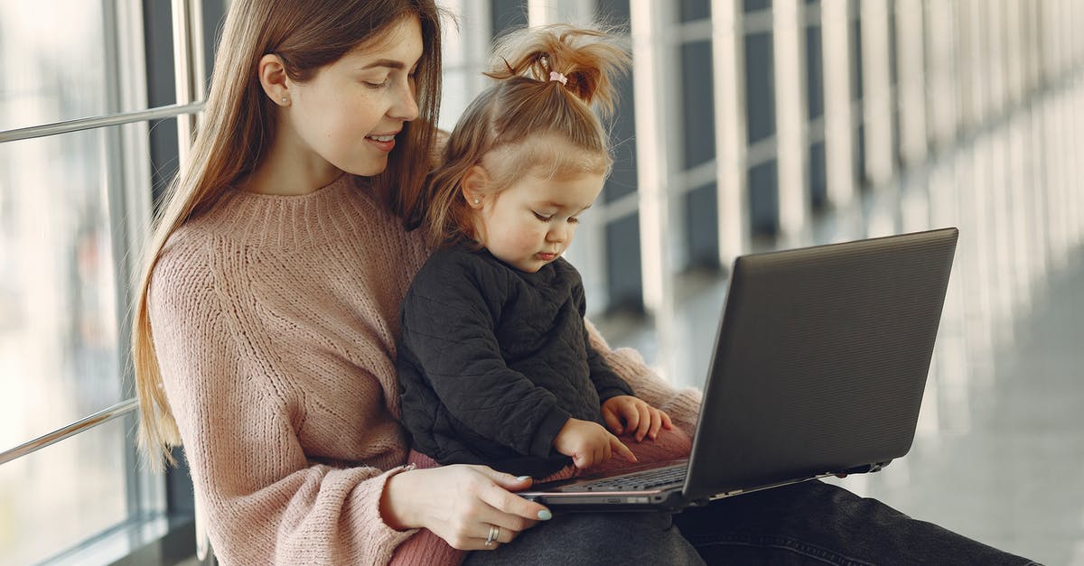 Share Steam games bought on parent account and computer to child account and computer - Cheerful young mother in casual clothes with cute blond girl on laps browsing netbook while sitting in modern building hallway in daylight and smiling Share Steam games bought on parent account and computer to child account and computer - Cheerful young mother in casual clothes with cute blond girl on laps browsing netbook while sitting in modern building hallway in daylight and smiling