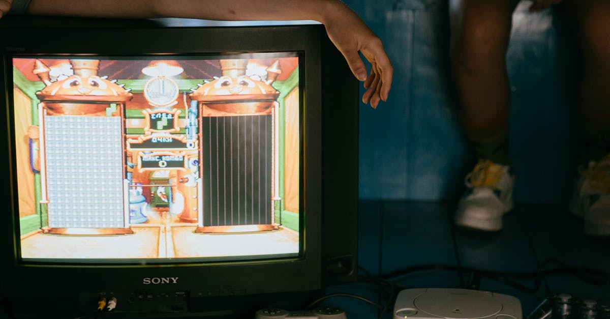 Sharing game between devices? - Crop unrecognizable female on modern monitor with video game on screen near ethnic partner Sharing game between devices? - Crop unrecognizable female on modern monitor with video game on screen near ethnic partner