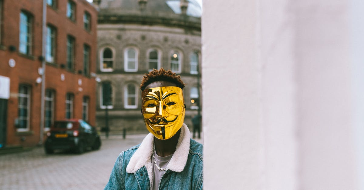 Should I actively fight as Torbjörn as far as damage output is concerned? - Unrecognizable African American activist in golden Anonymous mask standing near building on street in town and looking at camera Should I actively fight as Torbjörn as far as damage output is concerned? - Unrecognizable African American activist in golden Anonymous mask standing near building on street in town and looking at camera