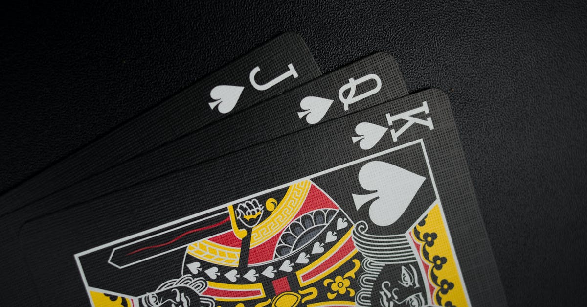 Should I keep giving cards when I'm King 13? - Black Playing Cards on Black Background