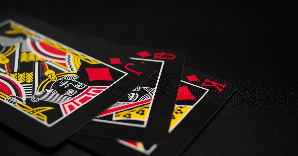 Should I keep giving cards when I'm King 13? - Black Playing Cards on Black Background
