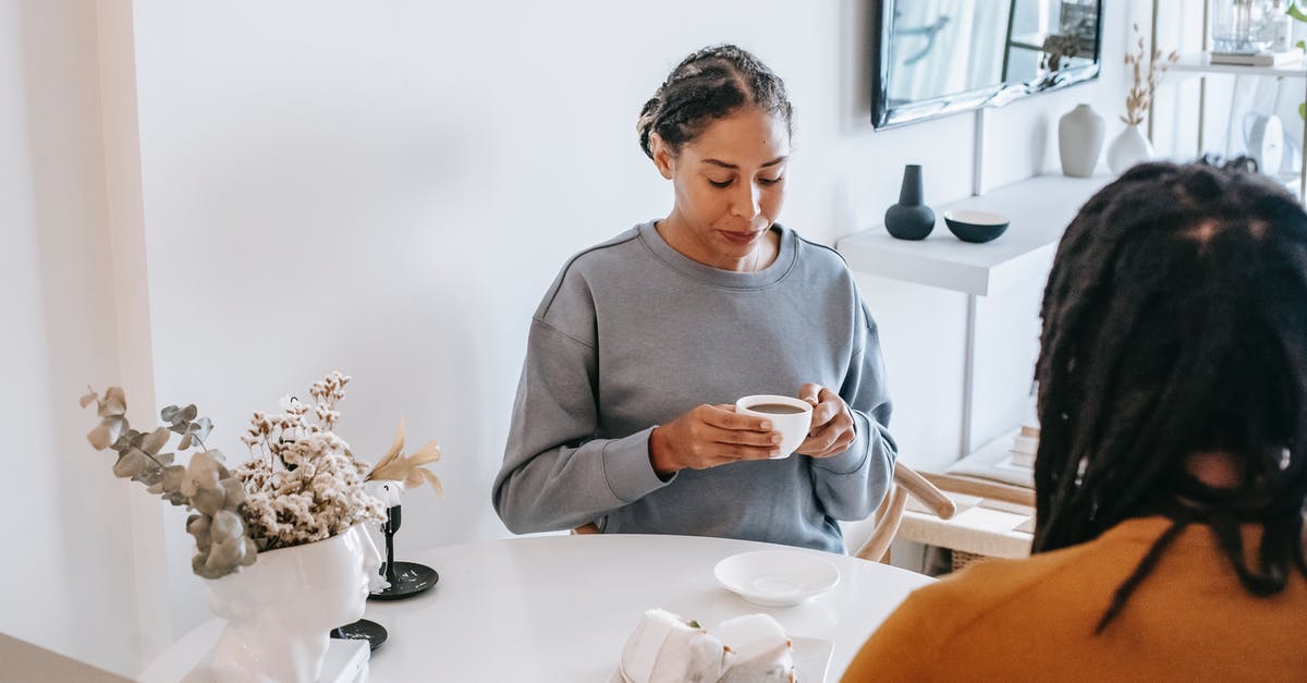 Should I spend time with my girlfriend? - Calm woman drinking coffee with boyfriend at home Should I spend time with my girlfriend? - Calm woman drinking coffee with boyfriend at home
