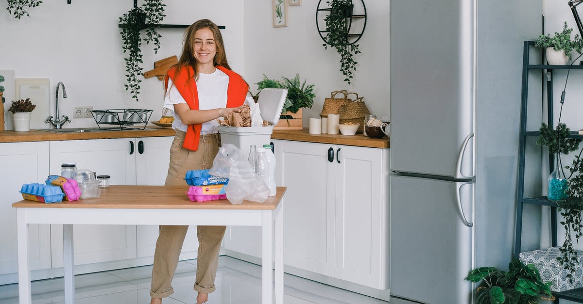 Should I use lower light level legendary weapons or higher light level lower tier weapons? - Young woman sorting waste in kitchen