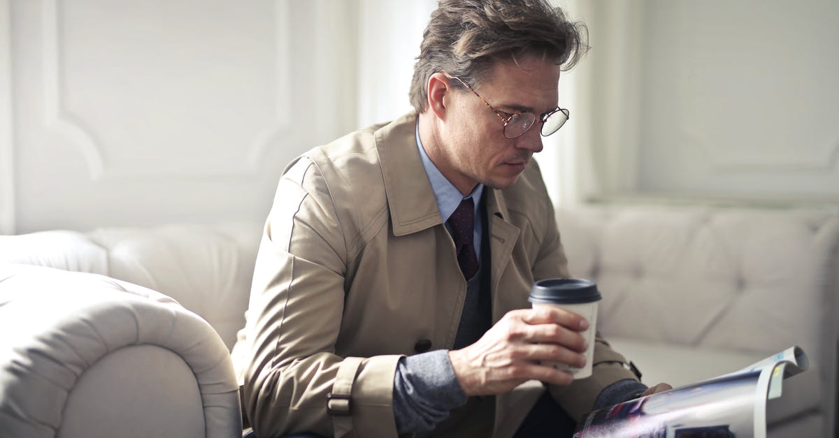 Should I wait until post-game to read Secret Reports? - Concentrated businessman with takeaway coffee reading magazine in living room Should I wait until post-game to read Secret Reports? - Concentrated businessman with takeaway coffee reading magazine in living room