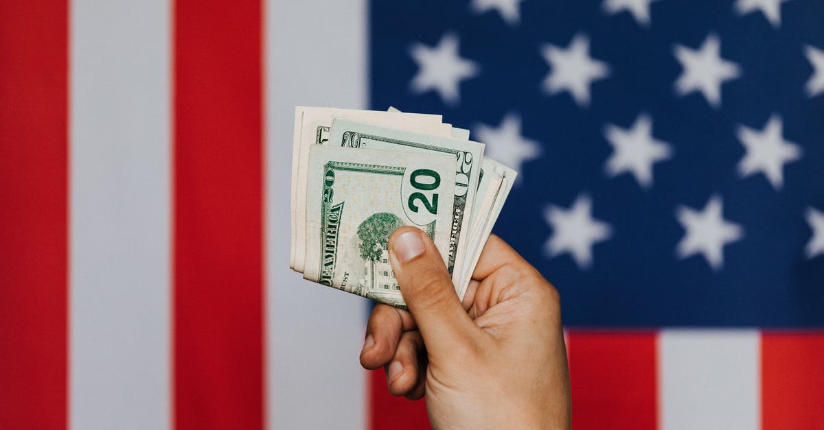 Show scoreboard belowname without a value - Unrecognizable male demonstrating dollars before official flag of USA on background Show scoreboard belowname without a value - Unrecognizable male demonstrating dollars before official flag of USA on background