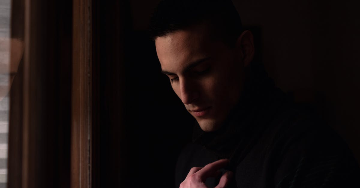 Shuffling items in a chest - Man in Black Hoodie Looking at the Window Shuffling items in a chest - Man in Black Hoodie Looking at the Window