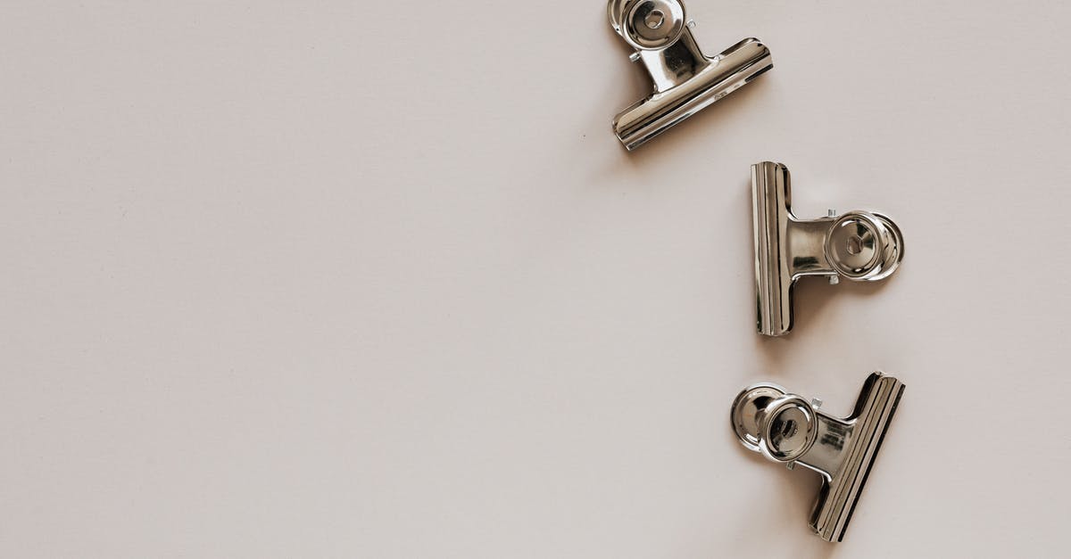 Similar item clumping in Jera break - From above of identical metallic clips made of solid material with smooth surface on beige background Similar item clumping in Jera break - From above of identical metallic clips made of solid material with smooth surface on beige background