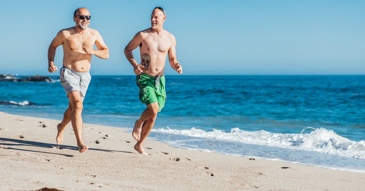 Skyrim Dragons Running When Hurt? - Man in Green and Blue Shorts Running on Beach