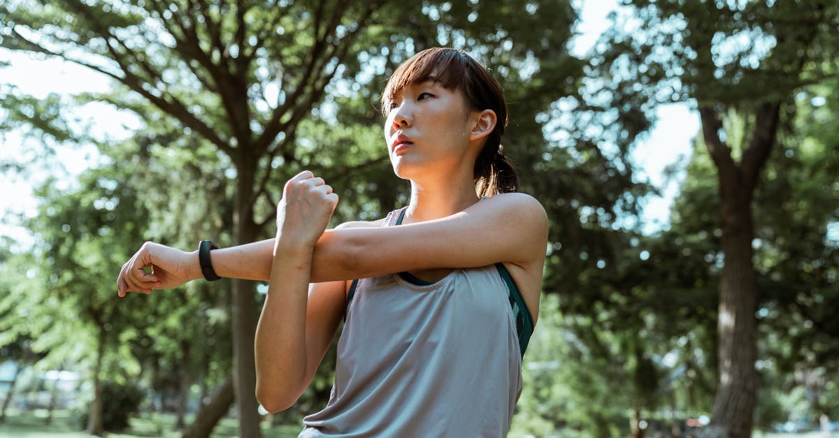 Skyrim wont open up via skse64. Glitches back to the homescreen - From below of serious Asian female athlete in sportswear stretching arms and back muscles while doing exercises in park