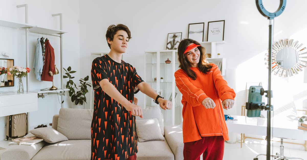 Slipping by BTs undetected - Woman in Red Pants Standing Beside Woman in Black and Red Floral Dress