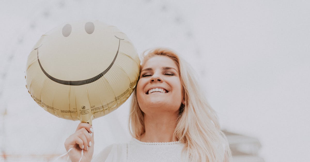 Smiley Badge effect and implications - Woman Holding a Smiley Balloon