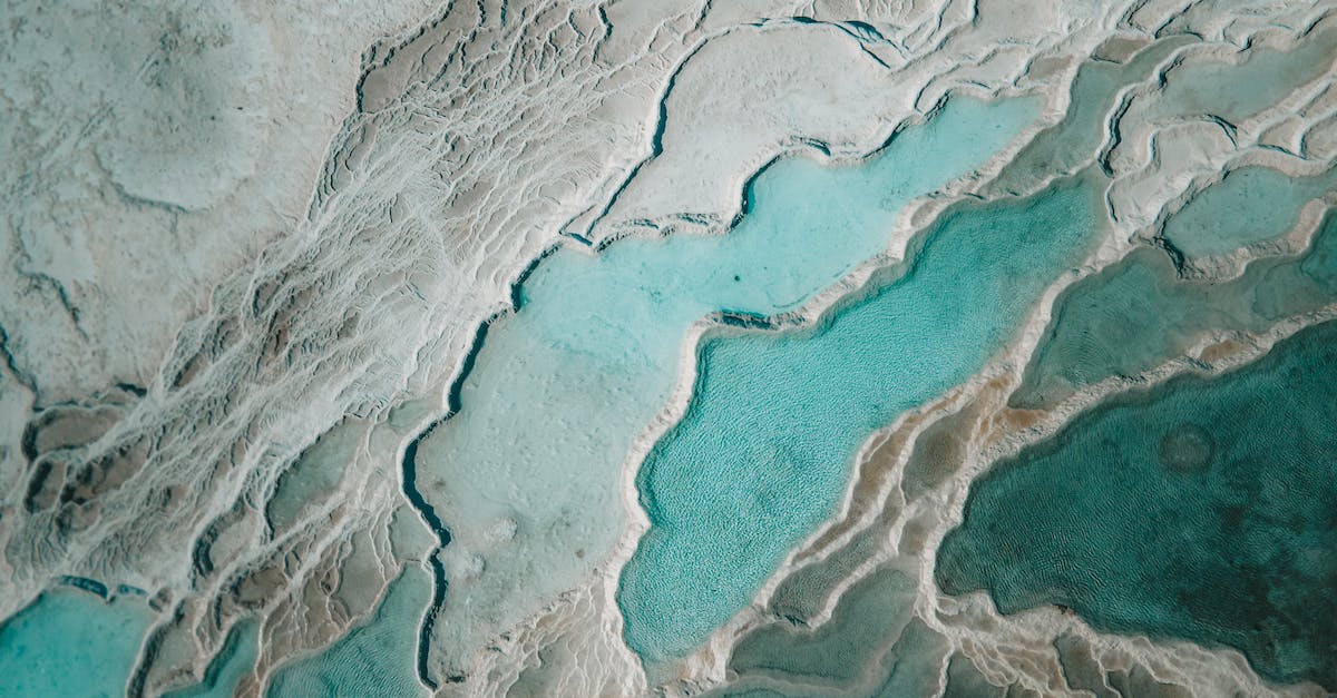 Snow Biome in Dungeon - Aerial Shot of Heaps of Icy Snow on a Glacier and Turquoise Melted Ice Snow Biome in Dungeon - Aerial Shot of Heaps of Icy Snow on a Glacier and Turquoise Melted Ice