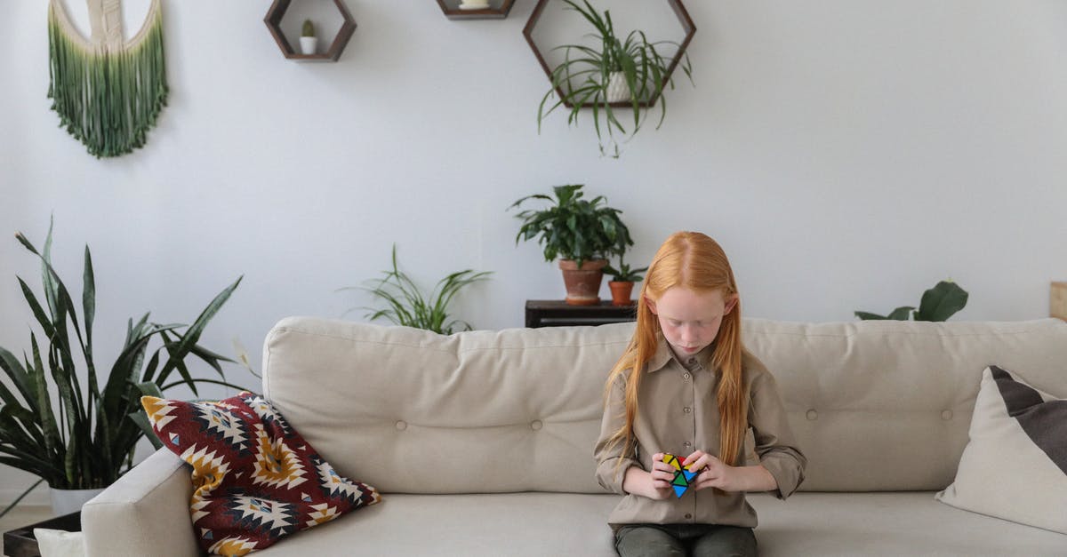 Sofa blocking puzzle [duplicate] - Attentive girl with bright brainteaser in modern room