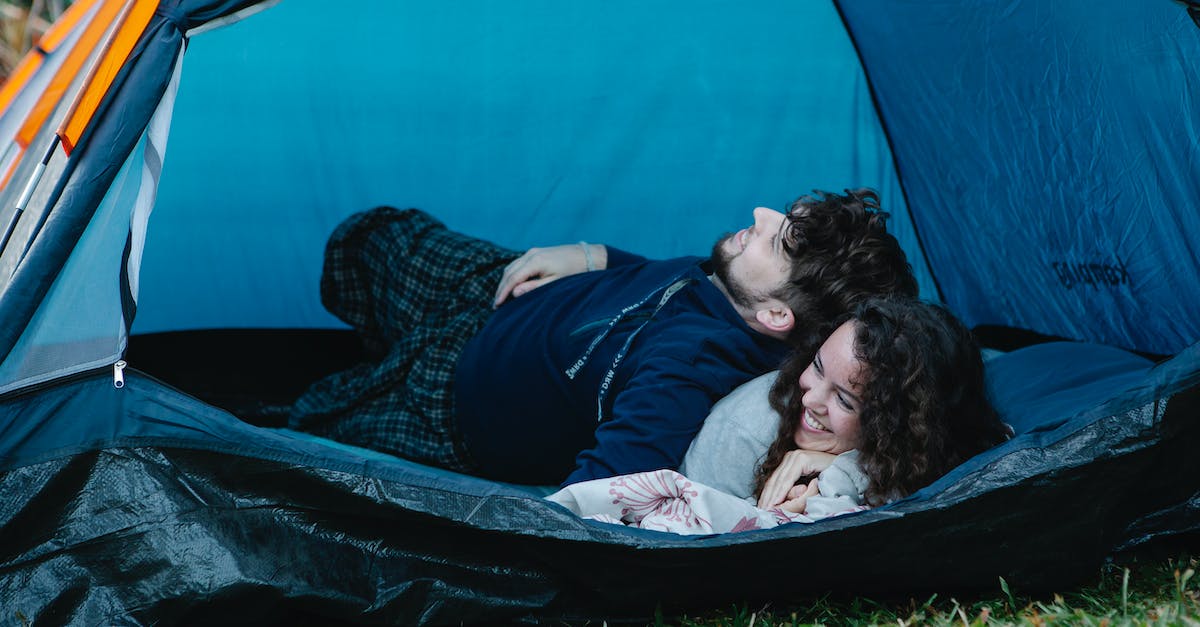 Some of my army camp troops have gone missing for the second time! - Young happy couple lying together in camping tent and enjoying weekend in countryside Some of my army camp troops have gone missing for the second time! - Young happy couple lying together in camping tent and enjoying weekend in countryside