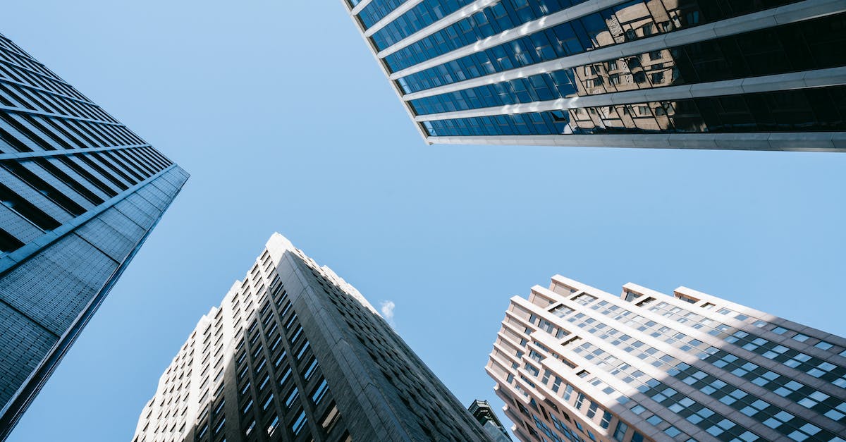 Songs developing a lag as they progress - Low angle of high business center with glass mirrored windows near concrete office towers in downtown
