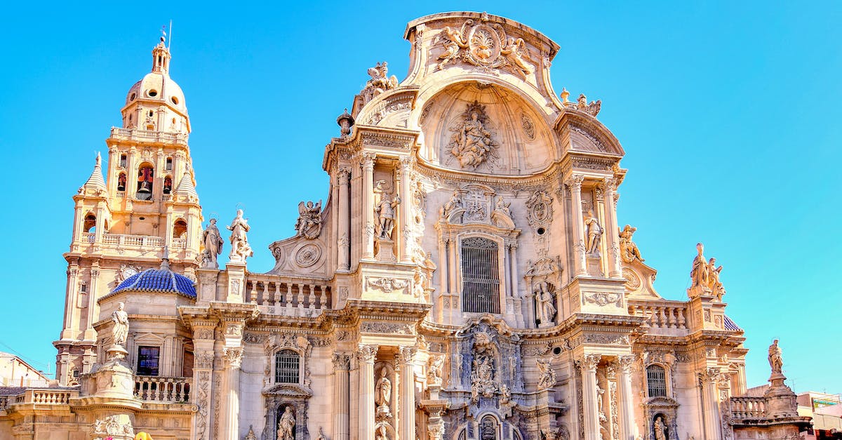 Spain's comeback - Beige Concrete Building Under Blue Sky
