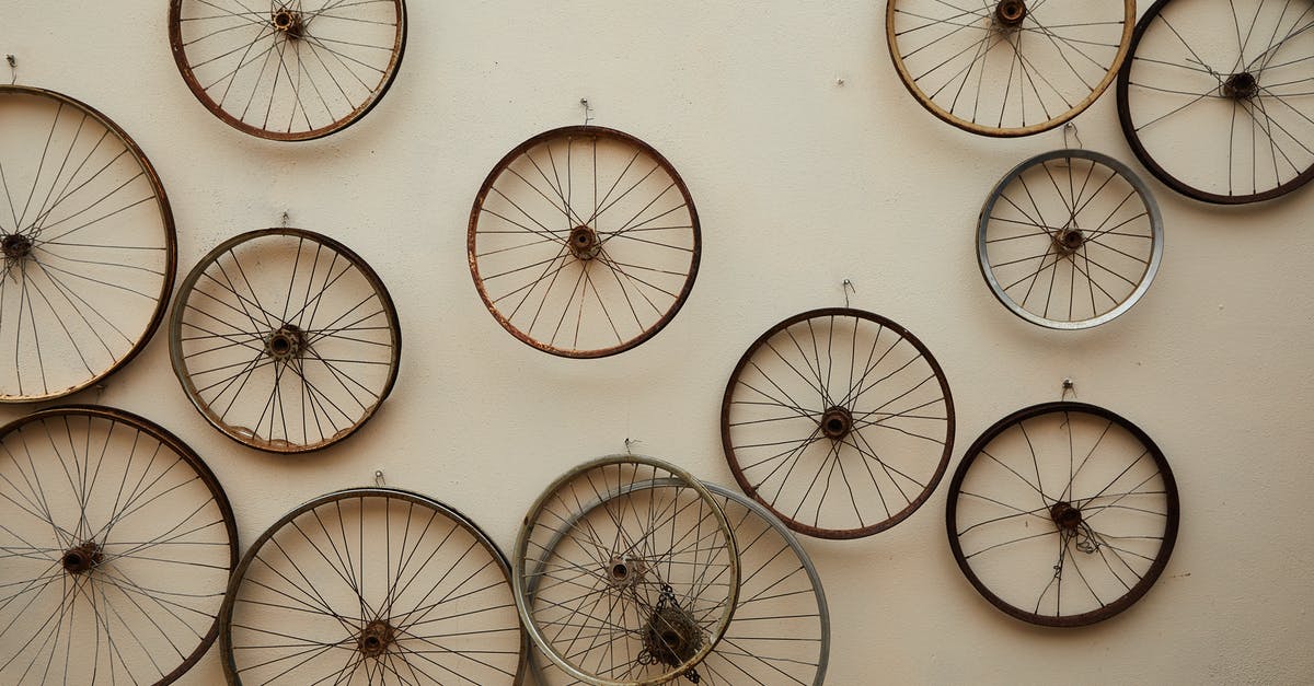 Specific Rules for Start of Round Damage - Different shapes and sizes spoke wheels hanging on light wall